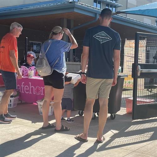 Image of family dropping off donations into bin